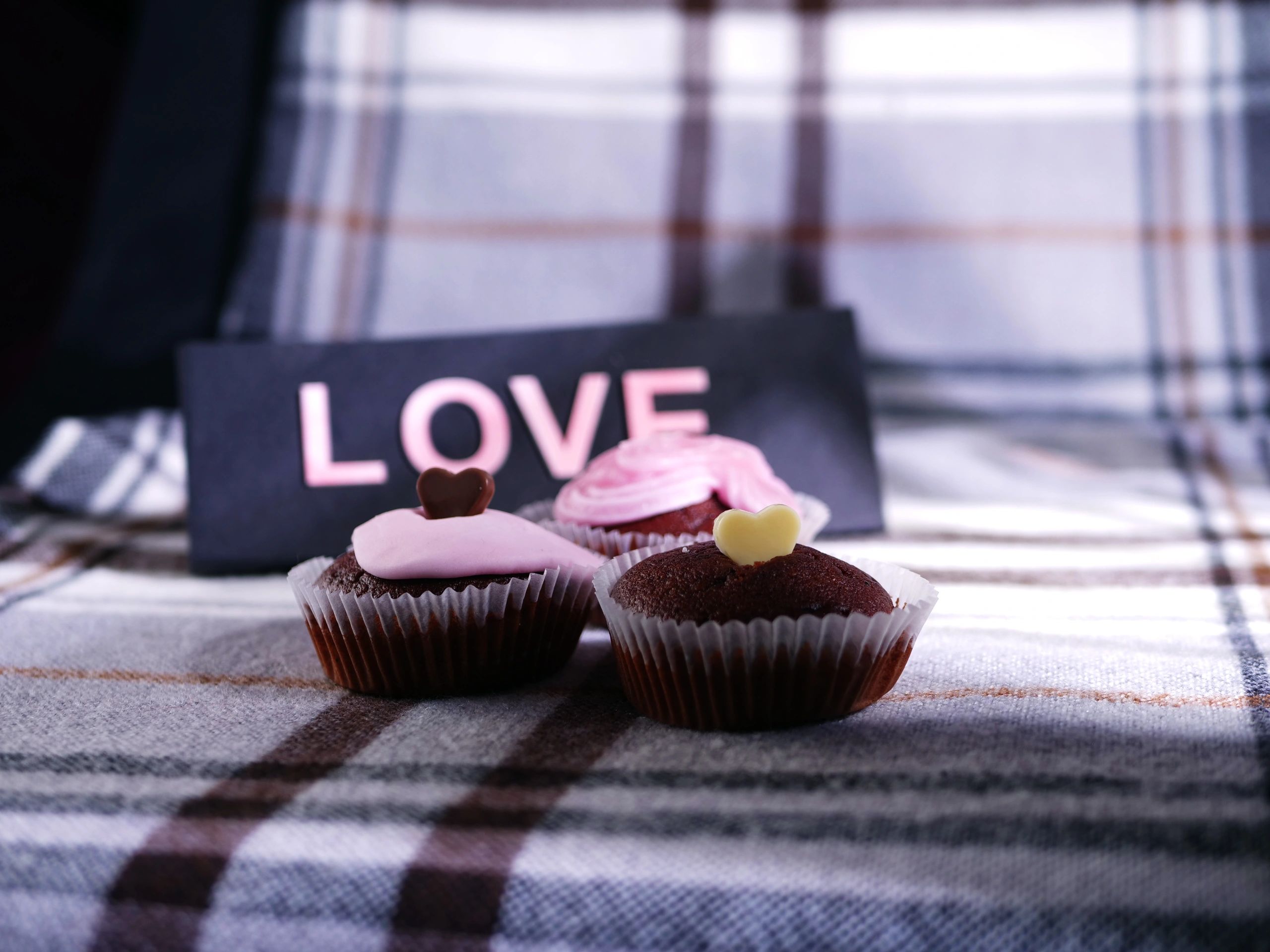 Chocolate cupcakes decorated with icing and heart sprinkles