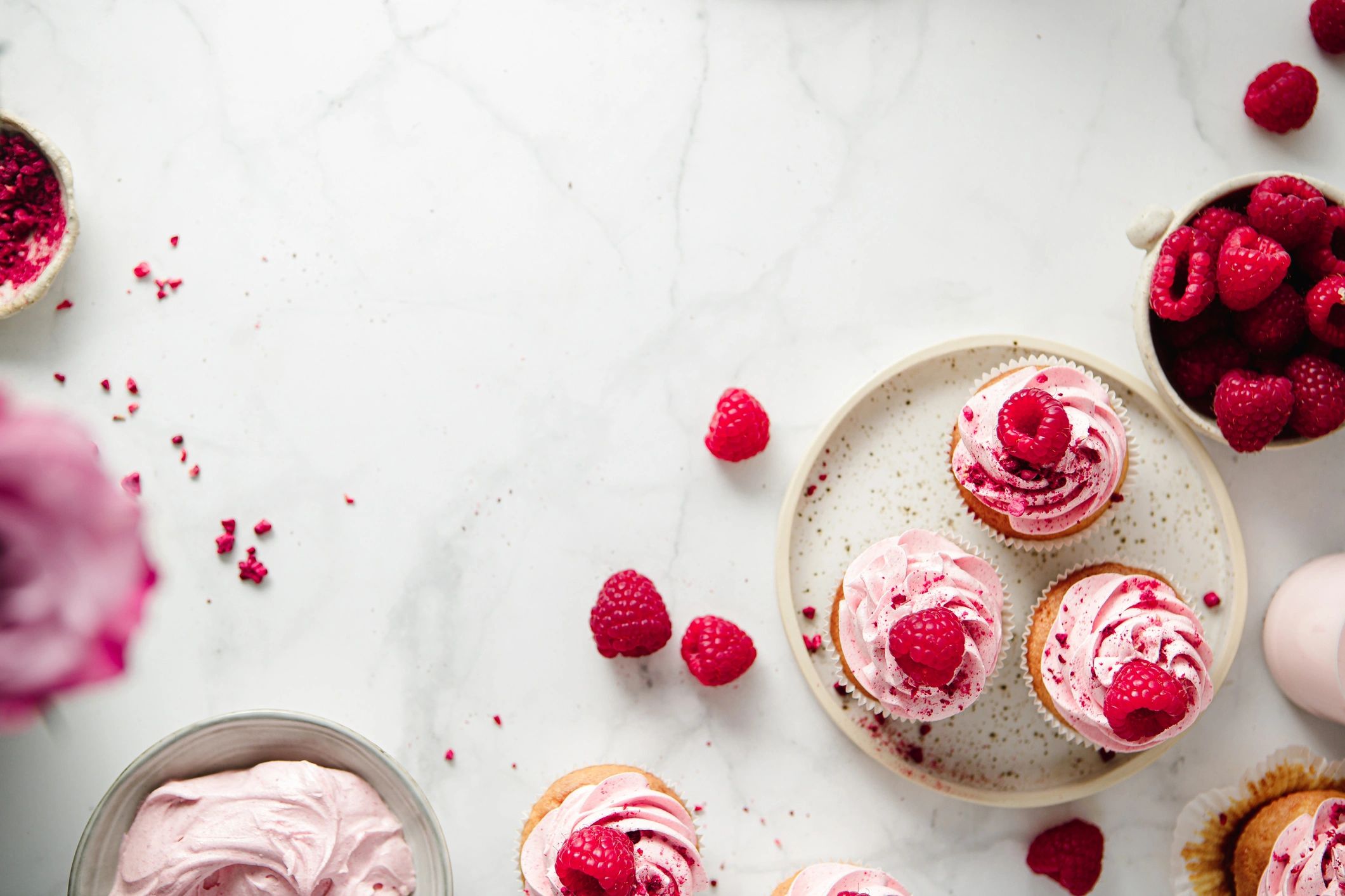 Freshly prepared raspberry cupcakes on a kitchen counter