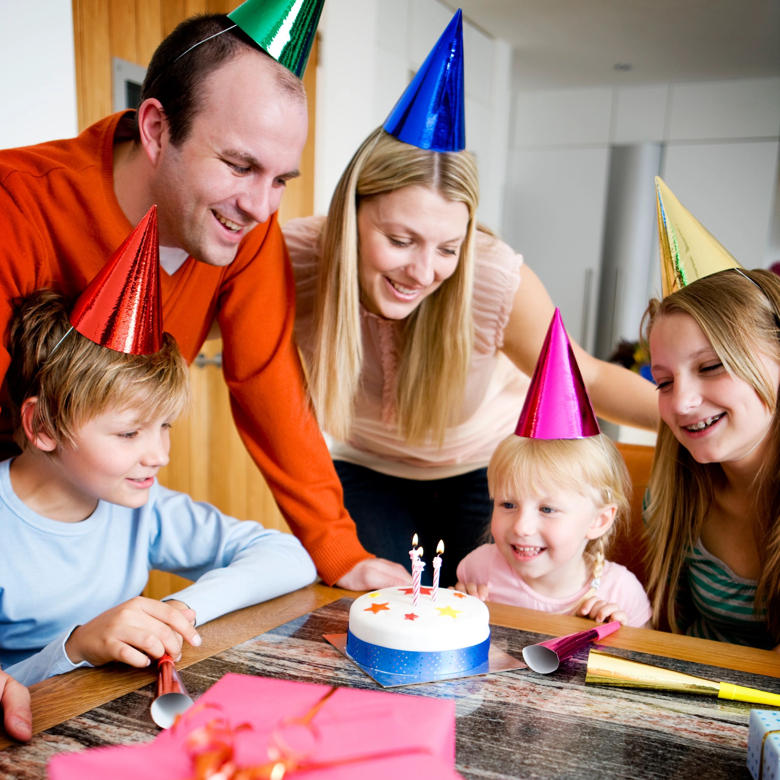 Family celebrating with a birthday cake