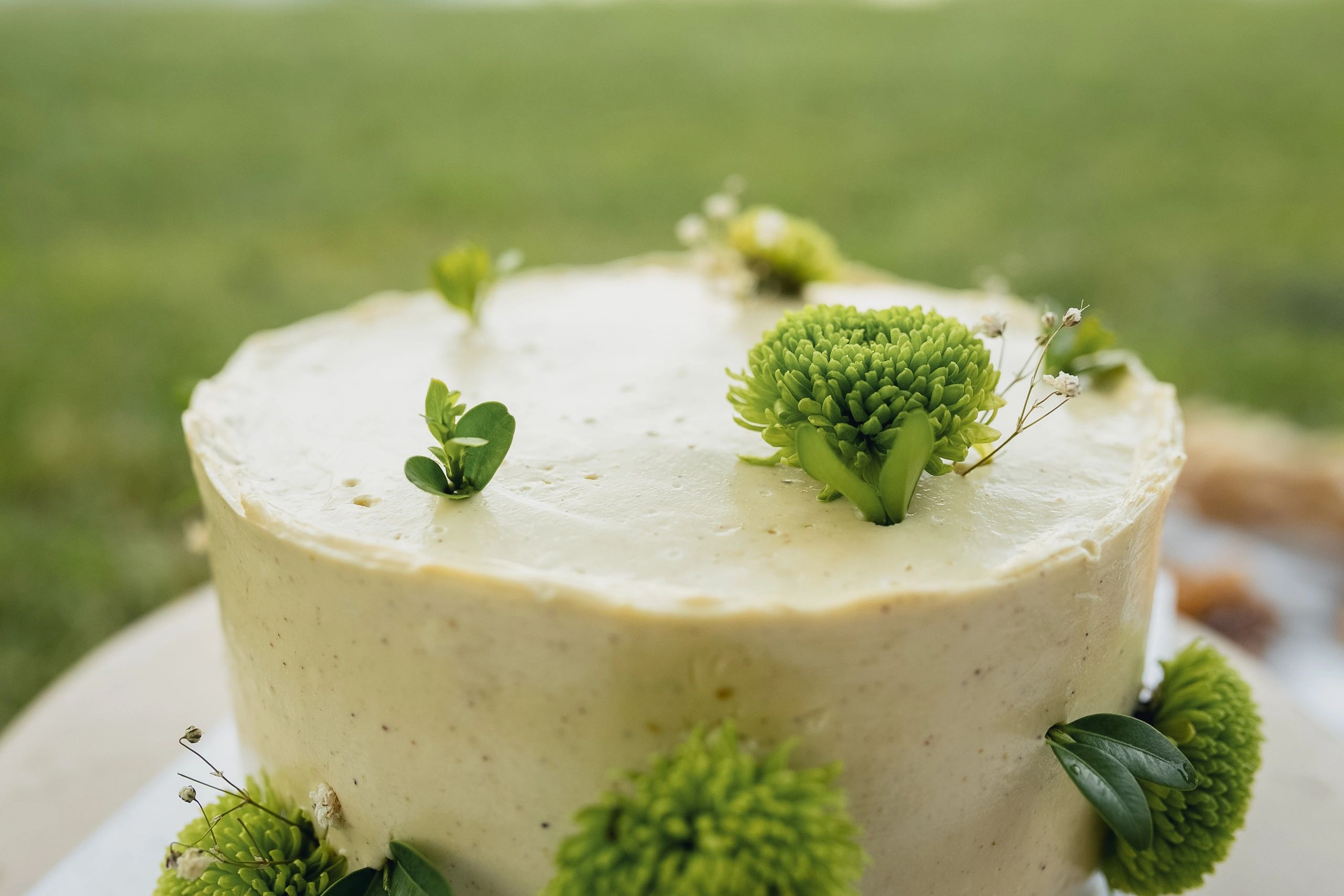 White wedding cake with green floral details