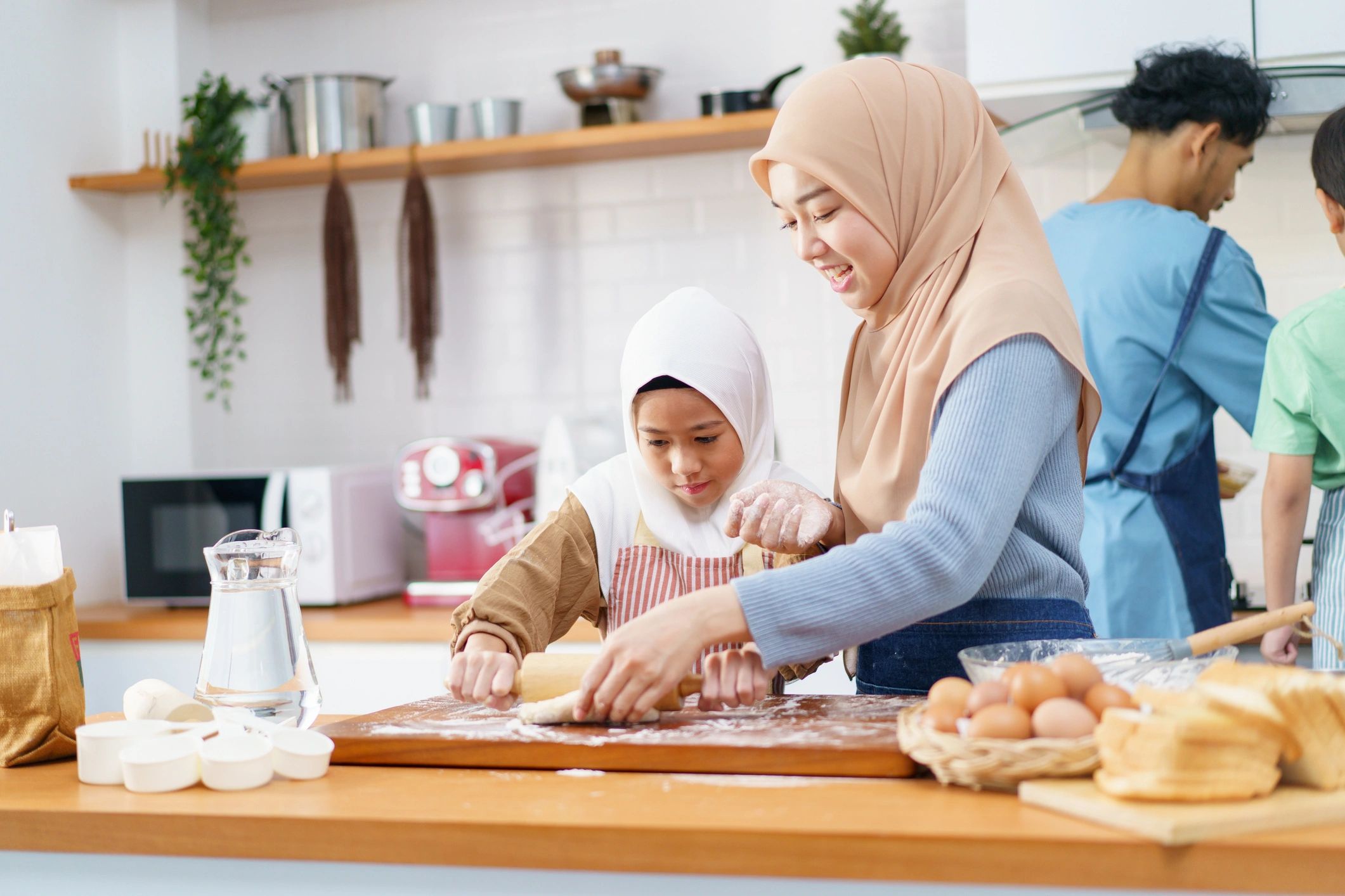 Parent and child baking together in a kitchen
