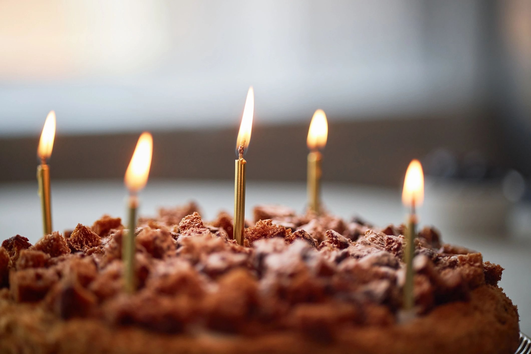 Chocolate birthday cake with lit candles