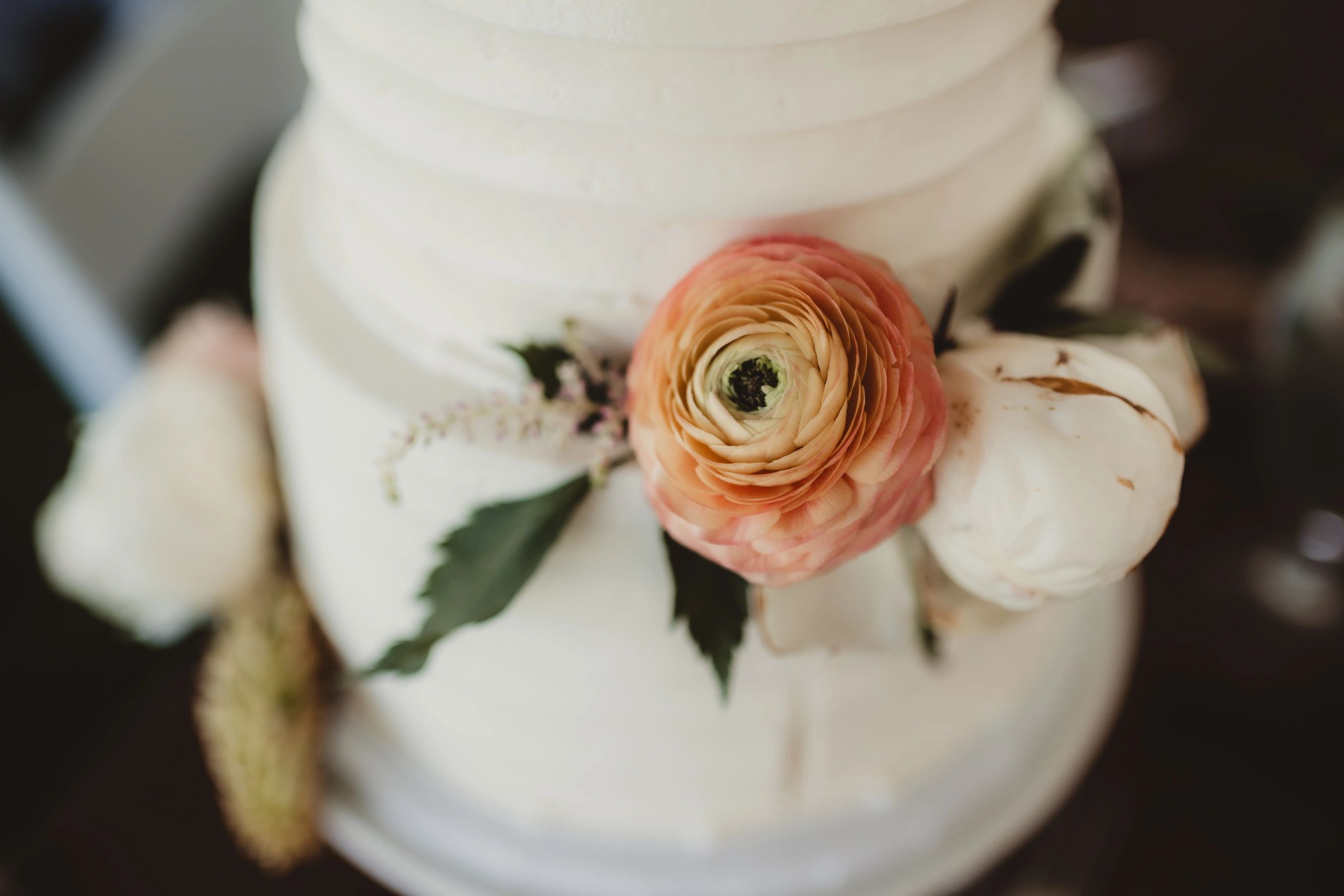 Close-up of wedding cake with flowers